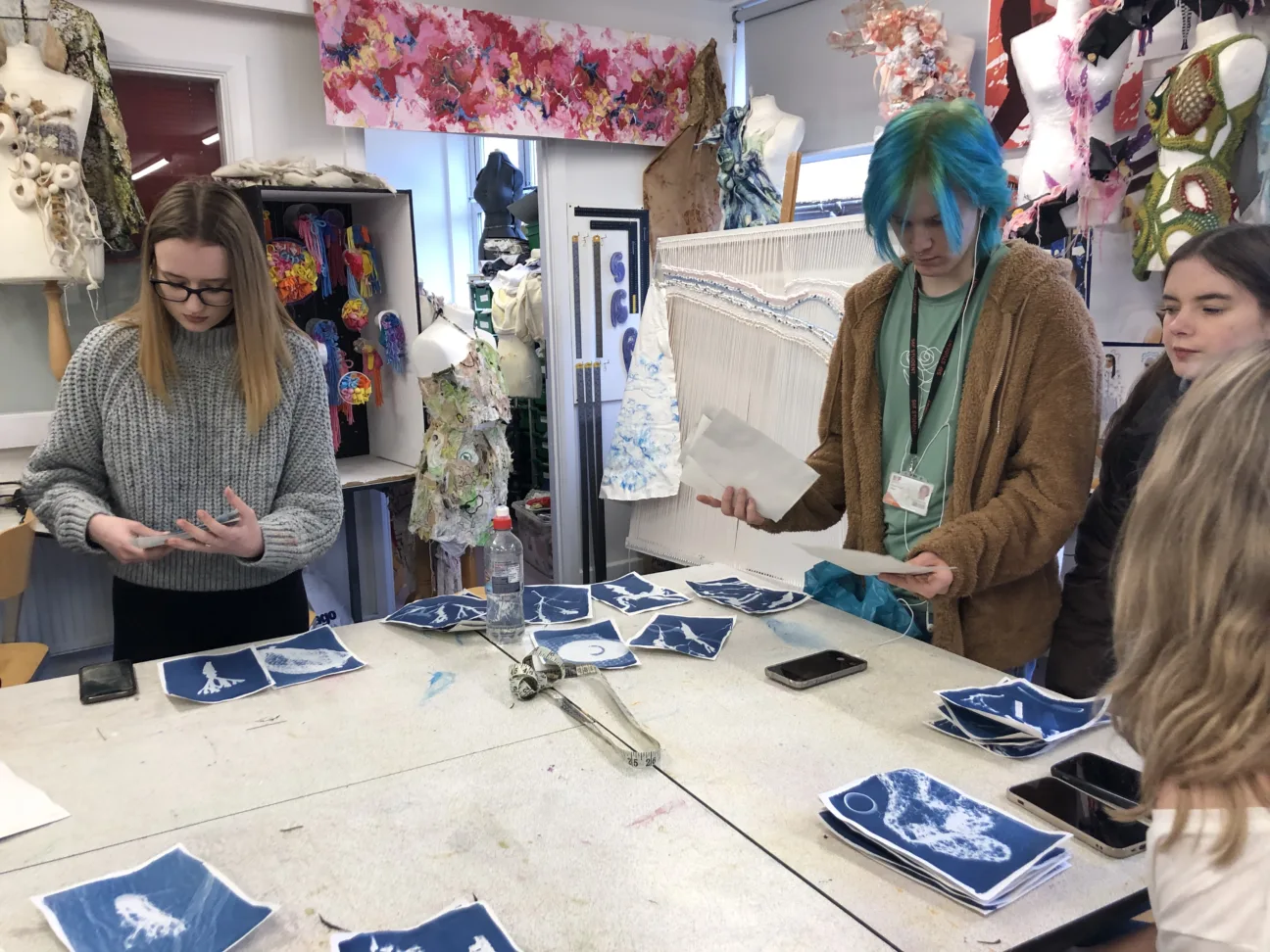 Participants stood looking at their created sun printed