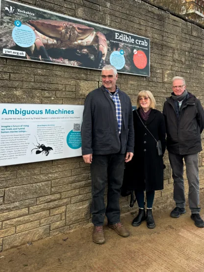 Dr Magnus Johnson; Dr Jane Pottas, Stuart Baines standing next to the ambiguous machines signage in Scarborough