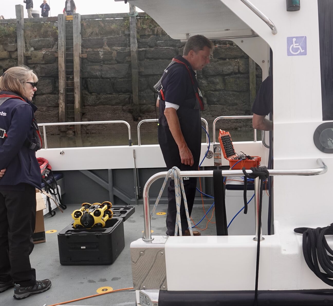 Wetwheels team with specialised underwater surveying equipment on the boat, preparing to leave for a survey.