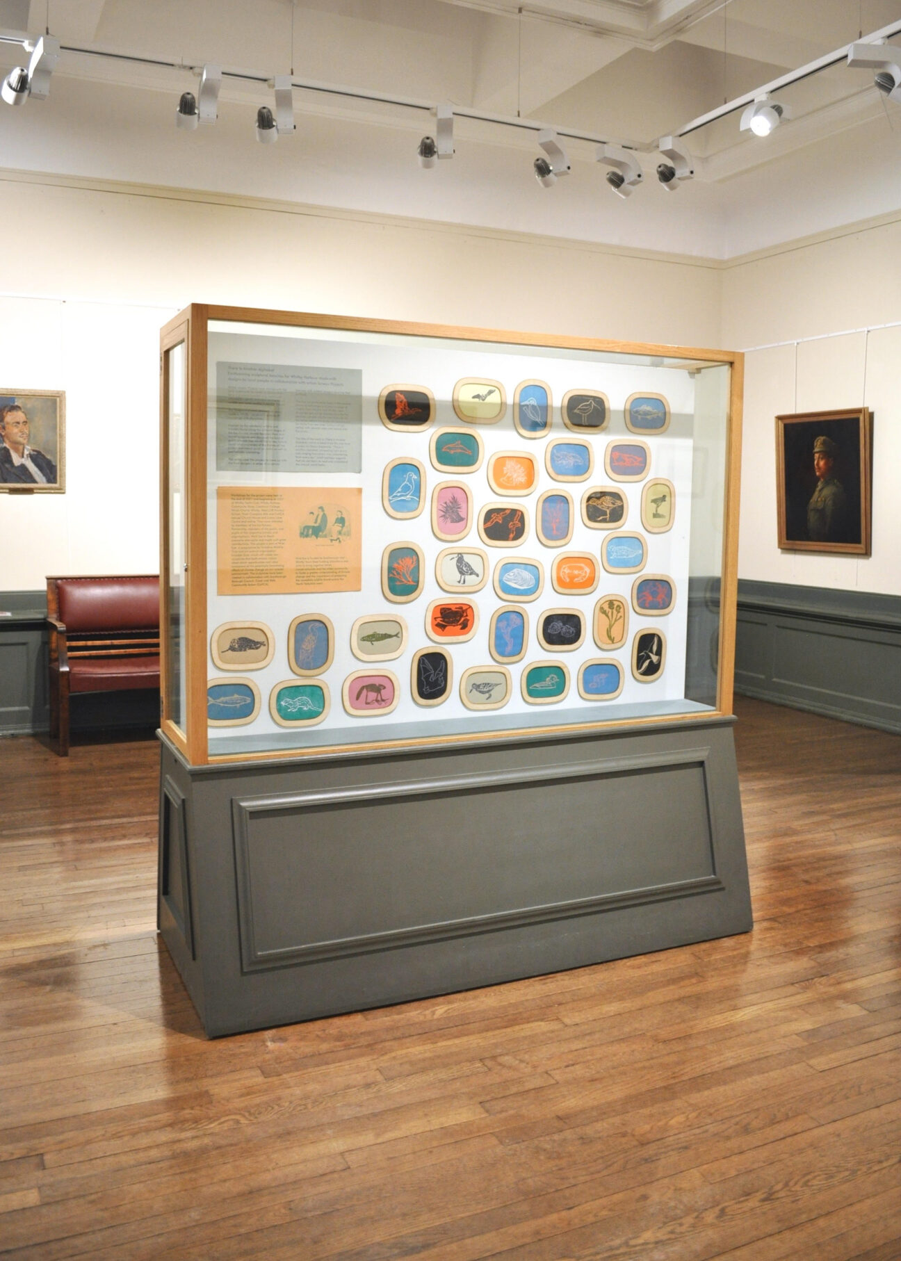 A gallery display filled with colourful lino prints