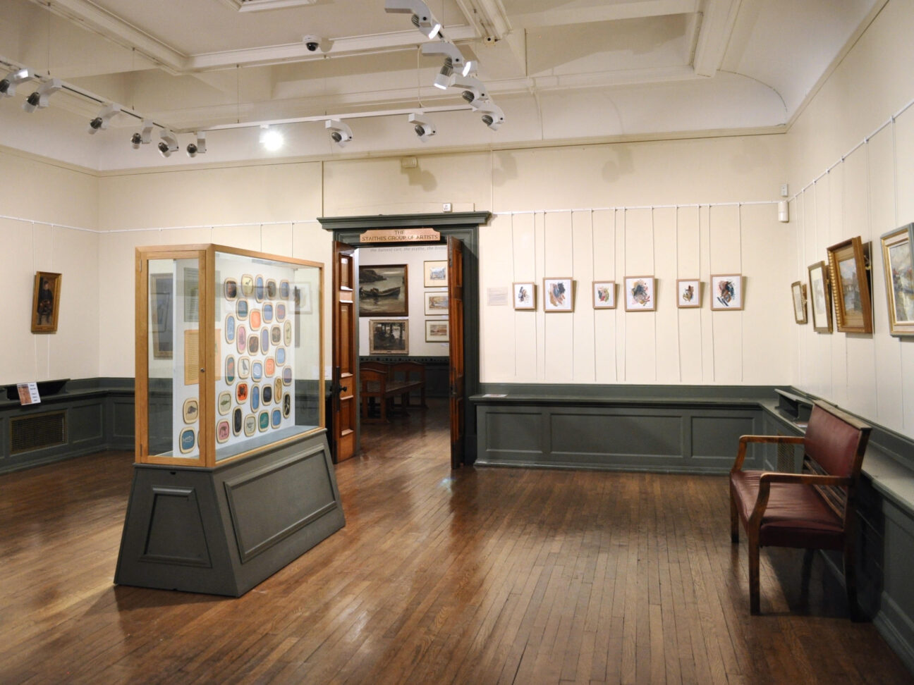 A gallery display filled with colourful lino prints