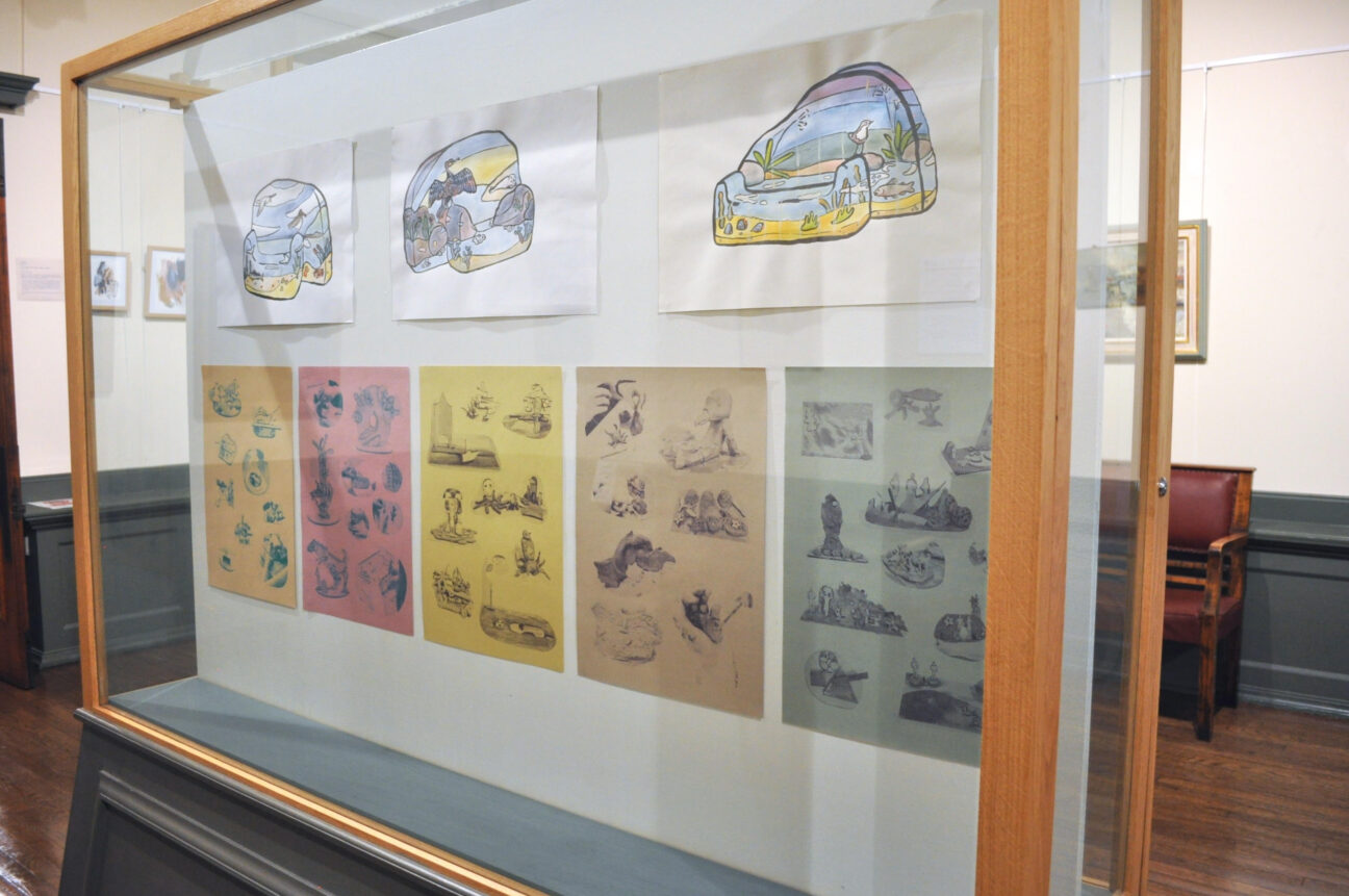 A gallery display filled with colourful lino prints.