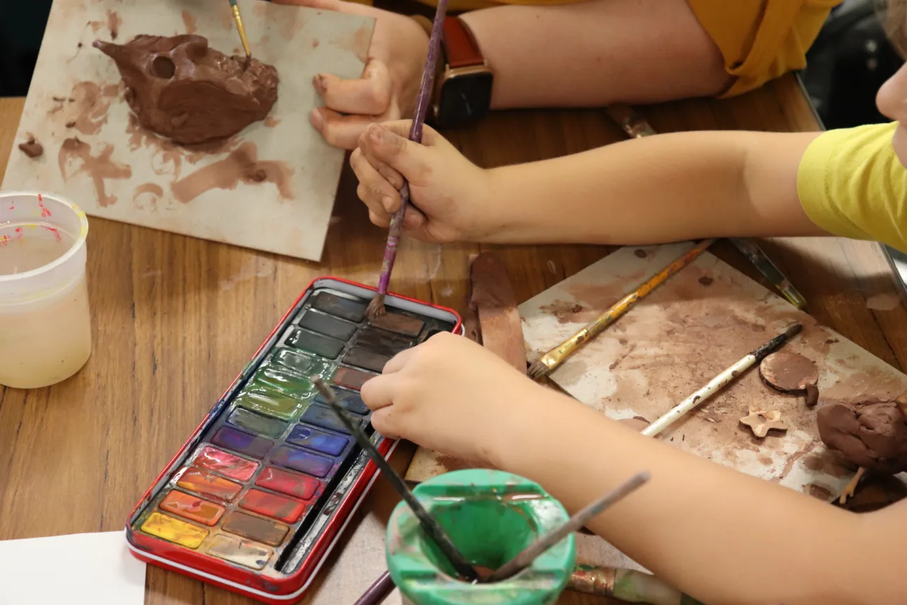 Juneau Projects creative workshops in progress with participants using clay and paint