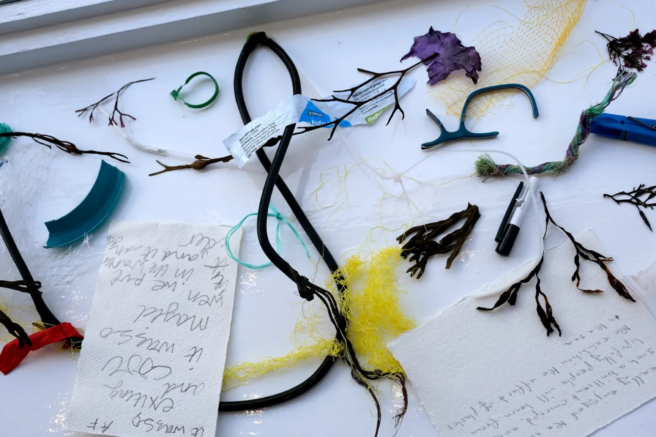 Materials collected from the beach by participants. Includes old glasses frame and bright yellow plastic netting.